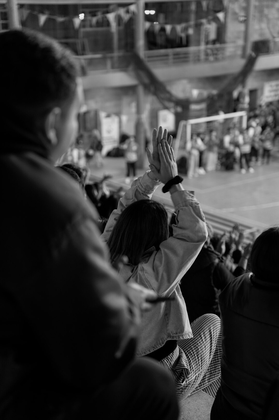 Group of colleagues joining hands in a high five at a workshop