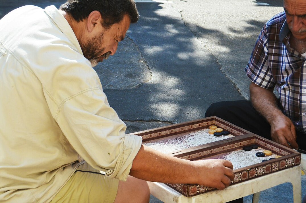 Two colleagues practicing a negotiation role play at a table
