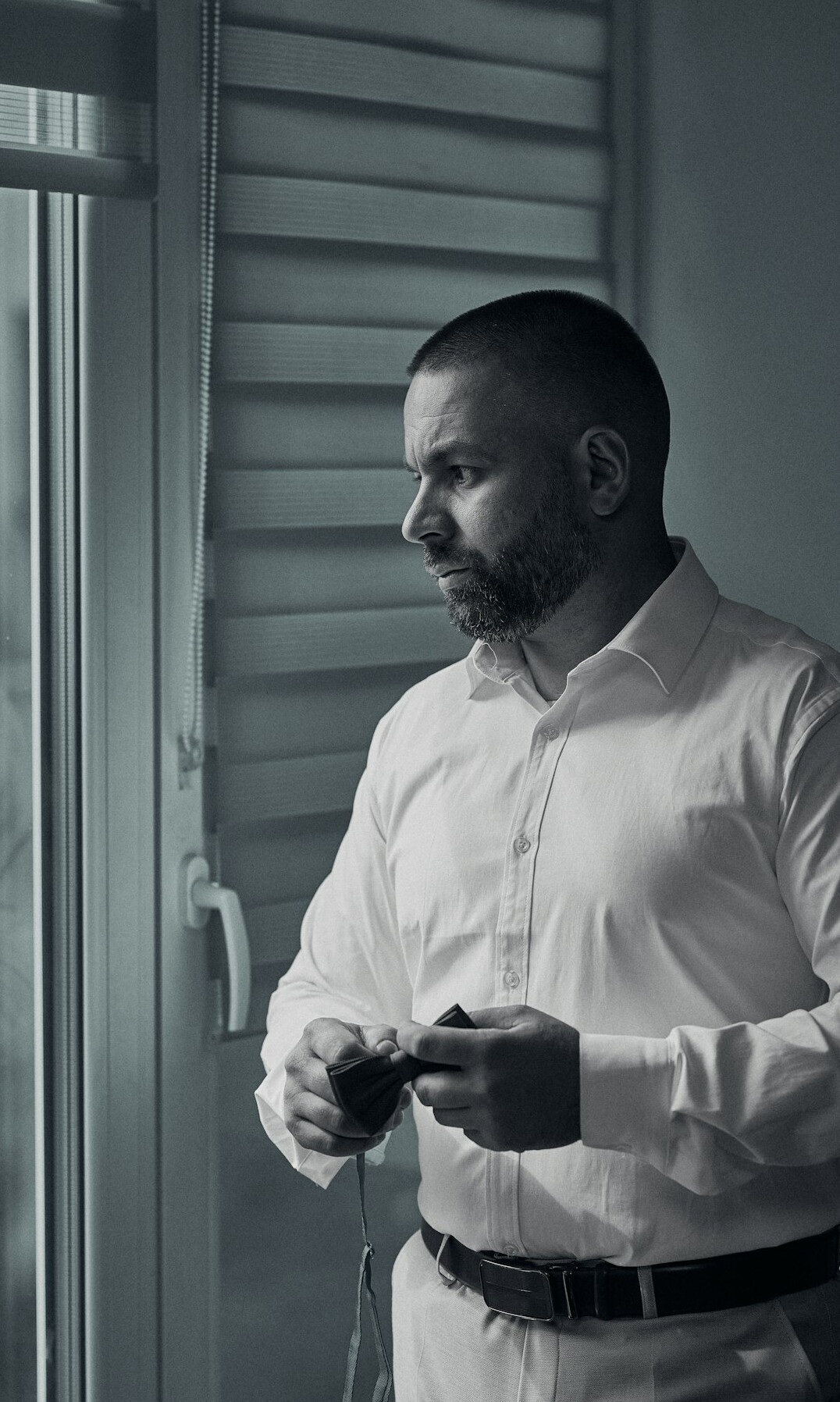 Portrait of a man with short hair and beard in a business shirt